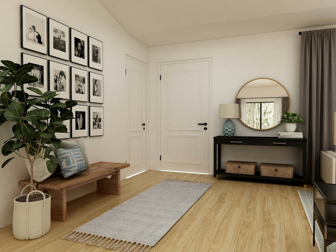 Small Entryway Ideas: 21 Smart Apartment Entrance Designs That Impress 2 Entryway with a black console table, round mirror, wooden bench and woven storage baskets