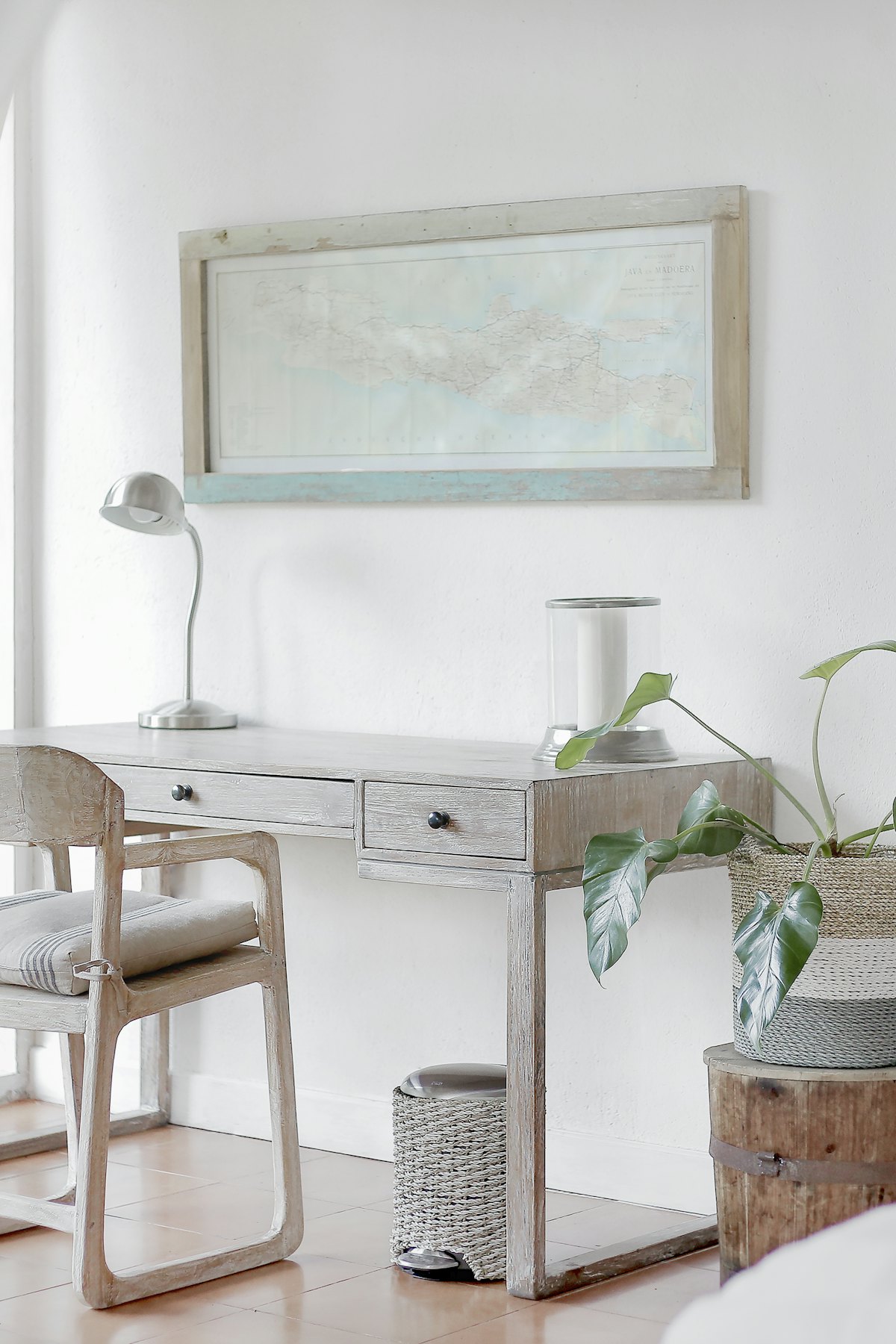 Balcony bar ideas with a slim wooden railing ledge, two bar stools, potted herbs, and city view on a small apartment balcony