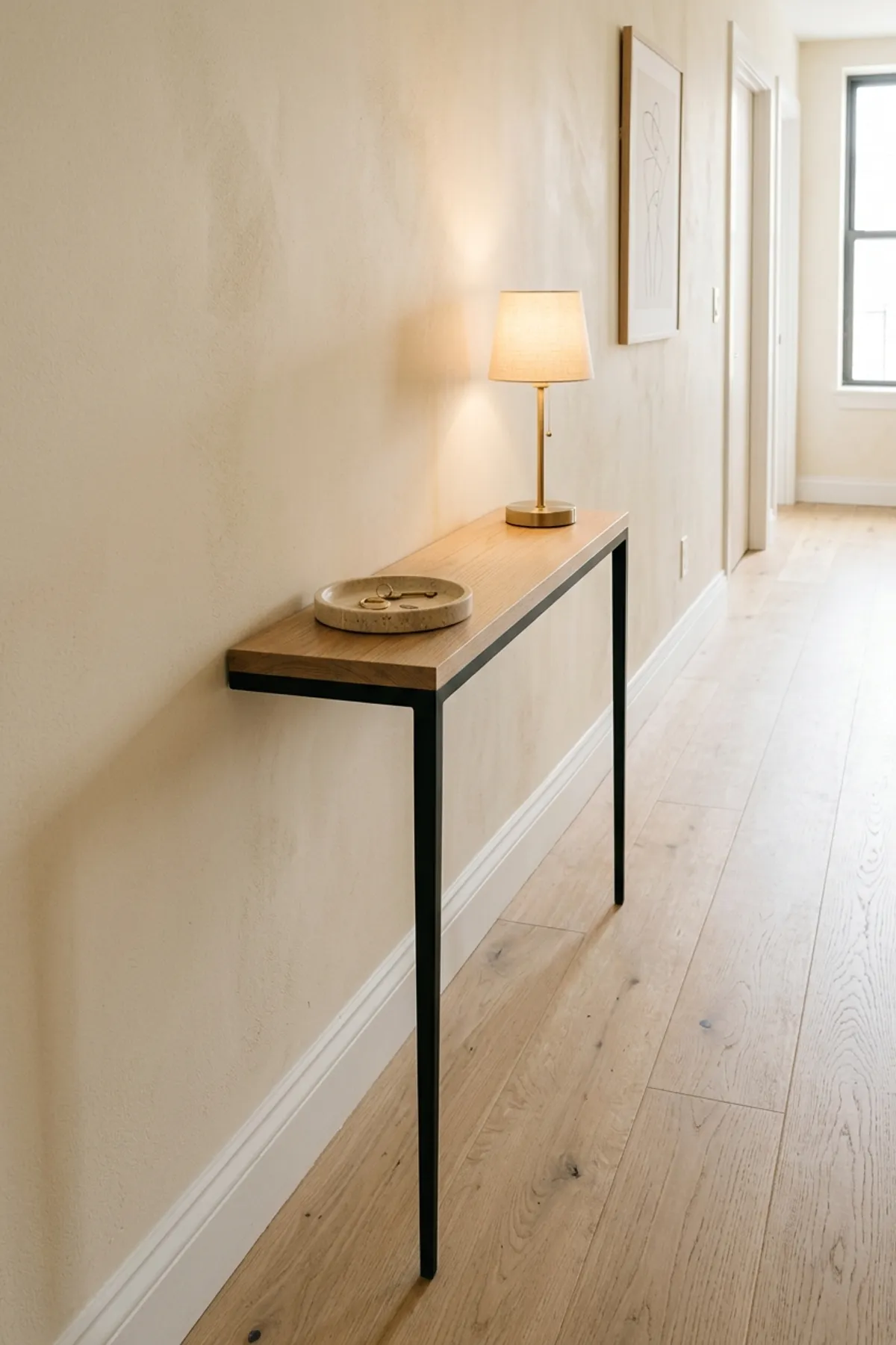 Ultra-slim 8-inch-deep console table illustrating smart narrow entryway ideas in an apartment hallway